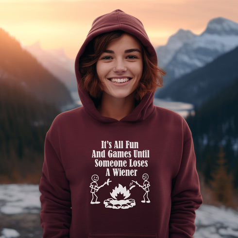 Our Camping hoodie features two adorable stick figure people roasting wieners over a cozy campfire. And with the hilarious slogan "It's All Fun & Games Until Someone Loses A Wiener," you'll be the life of the party at any camping trip!